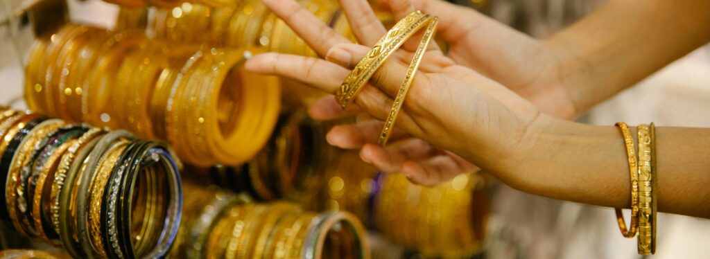 Indian artisan showcasing traditional velvet and latkan bangles at a wholesale bangle factory in Malad, Mumbai