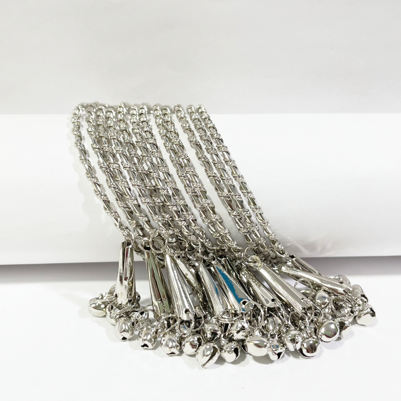 Detailed open view of 530 metal bangle with spread latkans for display